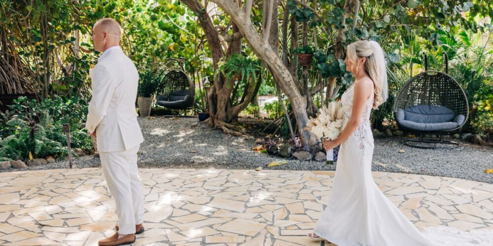 Couple sharing first look in tropical Aruba garden
